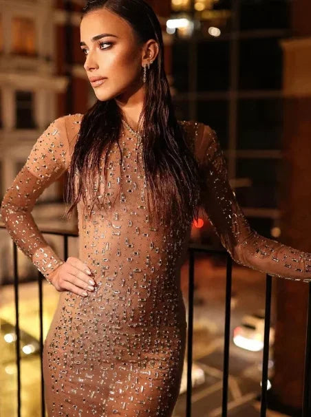 Women’s long-sleeve blush maxi dress featuring shimmering sequins and a flowing silhouette, perfect for formal occasions.