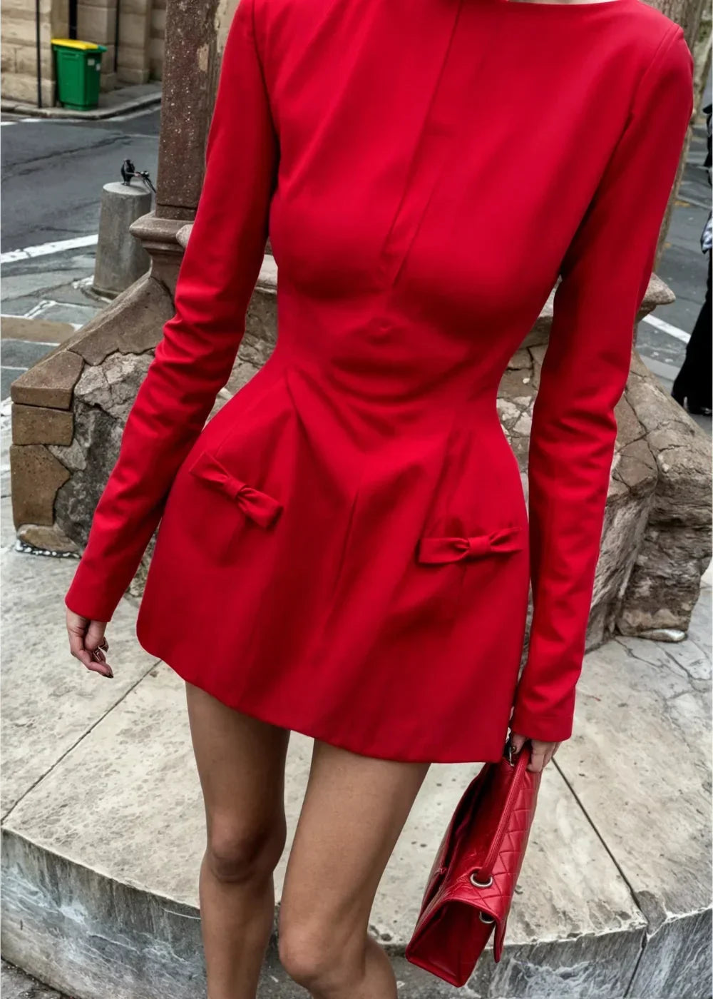 Women's long sleeve mini dress in soft cotton featuring playful bow accents on sleeves and waist, ideal for casual outings.