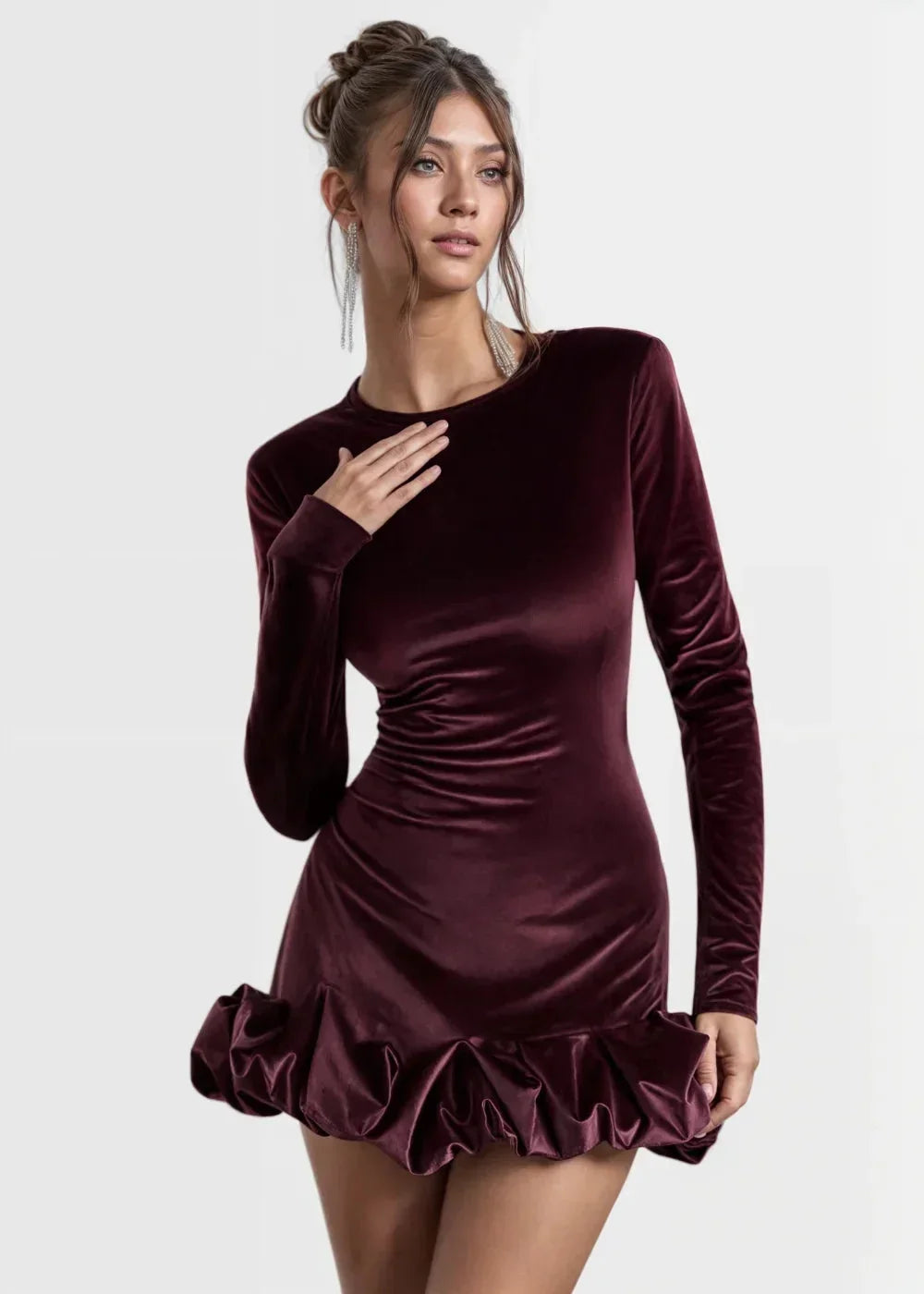 Women’s long-sleeve velvet mini dress featuring a ruffle hem and soft texture, perfect for both casual and formal occasions.