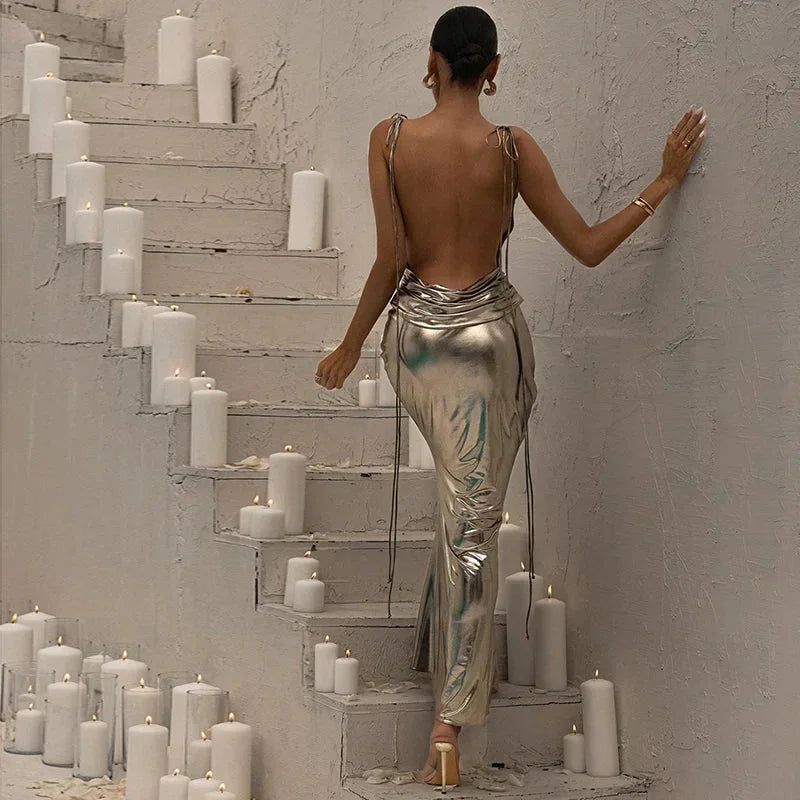 Women's metallic silver slip maxi dress featuring spaghetti straps and a sleek design, perfect for evening events.