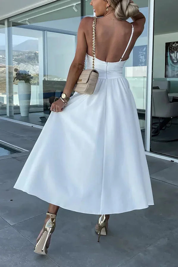 Women’s midi dress featuring a cut-out waist, side pockets, and made from soft, breathable fabric in a stylish design.