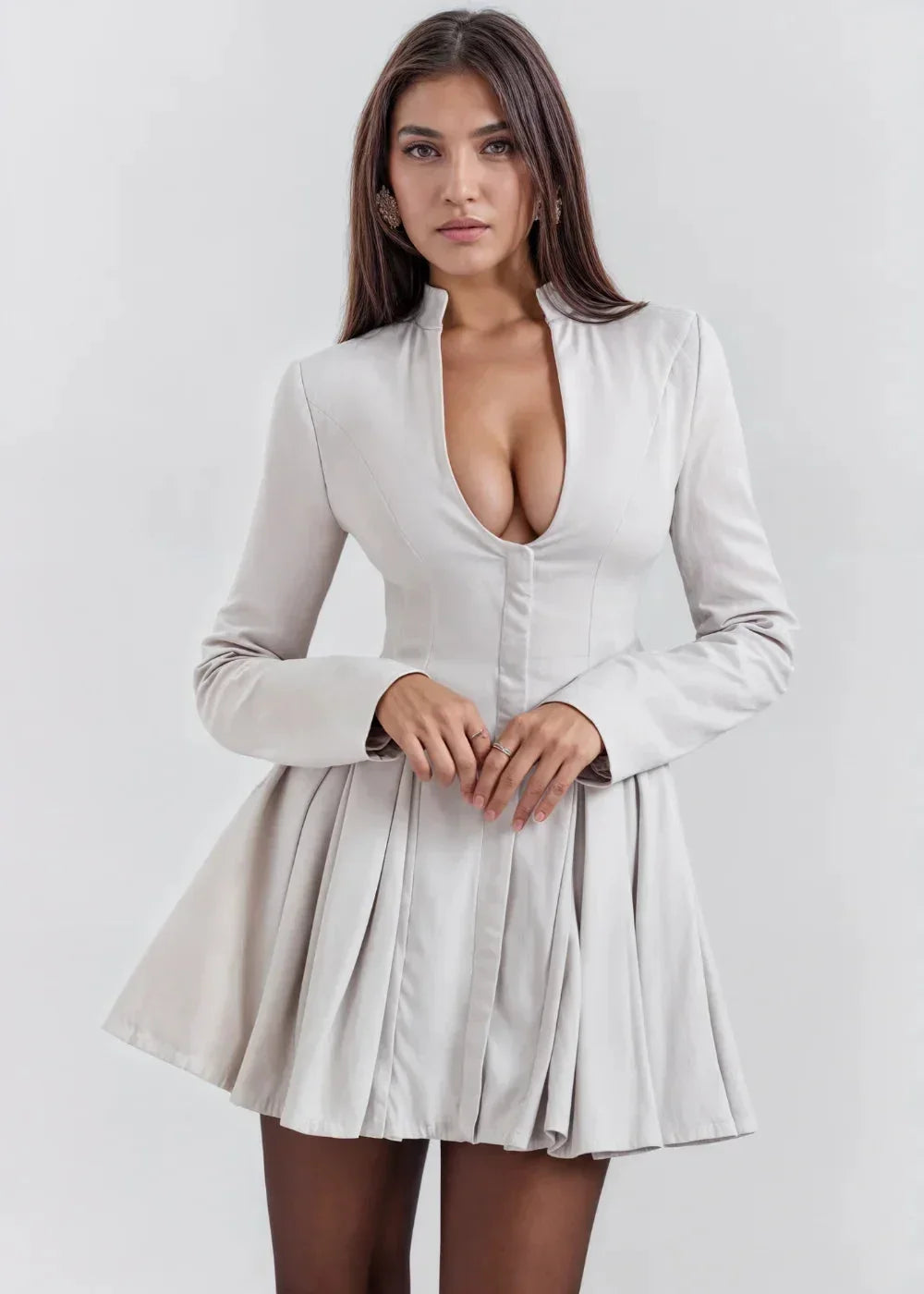 Women’s mini dress featuring a pleated skirt and a deep neckline, crafted from soft, breathable fabric for comfort.