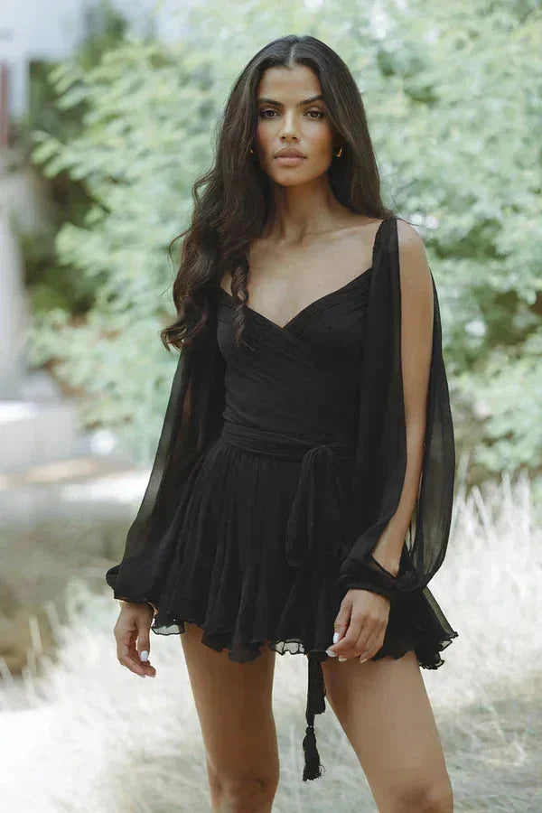 Women’s off-shoulder black mini dress with ruffle detail, crafted from lightweight fabric for a breezy, comfortable fit.