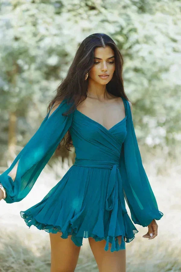 Dark teal off-shoulder mini dress featuring ruffle detail, made from lightweight fabric for a breezy fit. Perfect for summer…