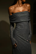 Grey off-shoulder maxi dress with flare sleeves, featuring a glitter fabric for subtle sparkle and a flowing silhouette.