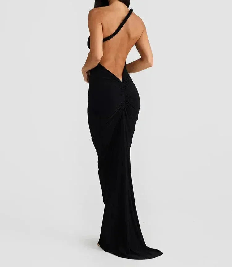 Black women's off-shoulder ruched fitted backless maxi dress made from soft, stretchy fabric for a flattering silhouette.