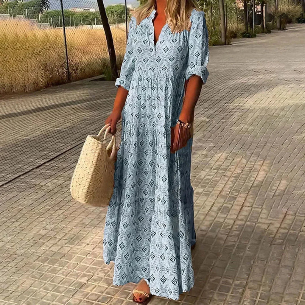 Women’s patterned v-neck maxi dress with rolled sleeves, made from soft cotton blend, featuring a vibrant floral design.