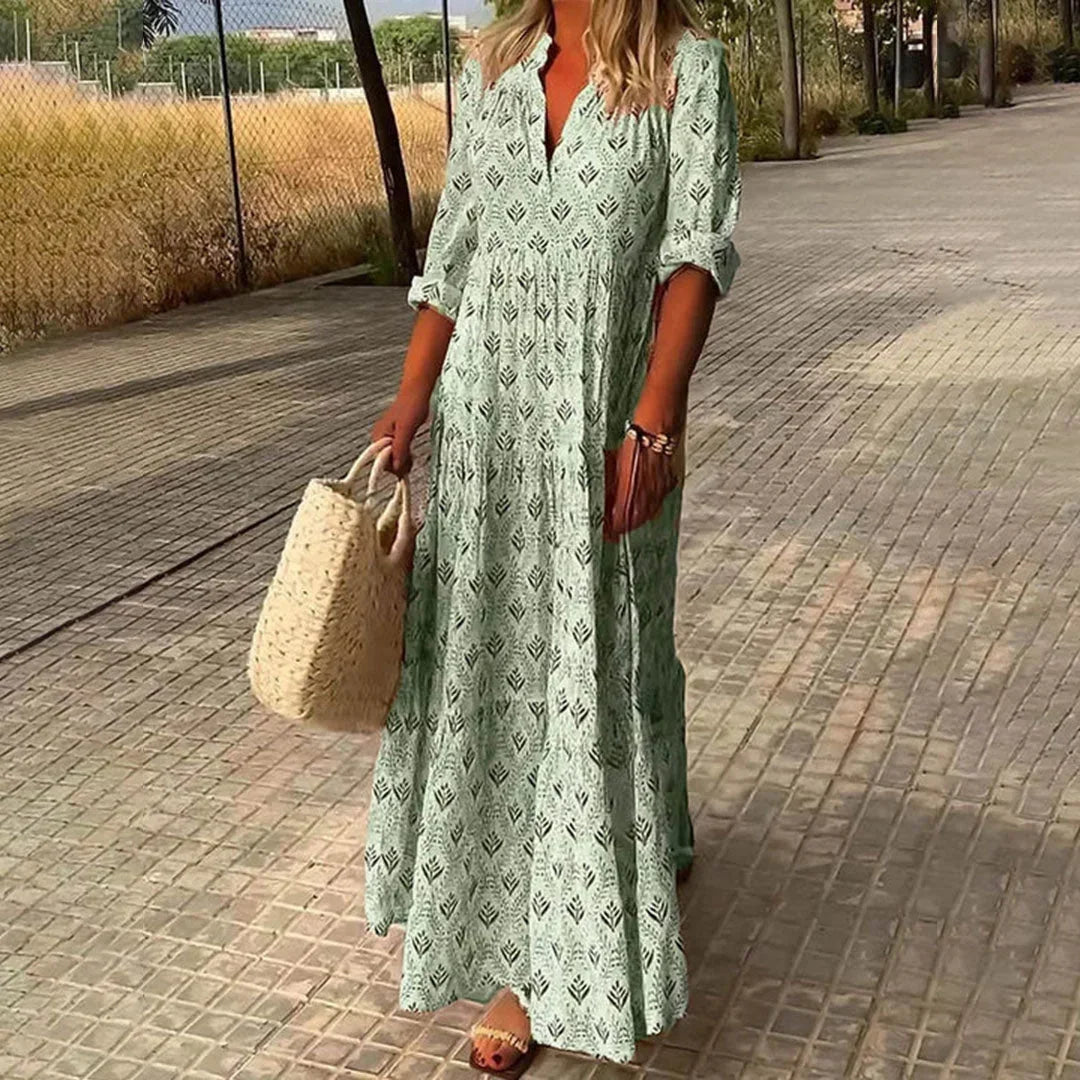 Green women's patterned v-neck maxi dress with rolled sleeves, featuring a breathable fabric and flowing silhouette for…