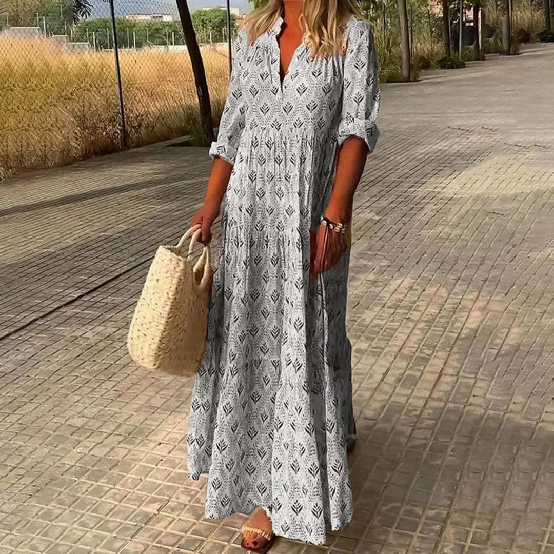Grey women's patterned v-neck maxi dress with rolled sleeves, featuring soft fabric and a flowing silhouette for comfort.