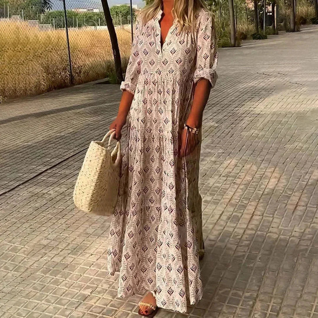 Pink women's v-neck maxi dress features a patterned design and rolled sleeves, made from soft, breathable fabric.