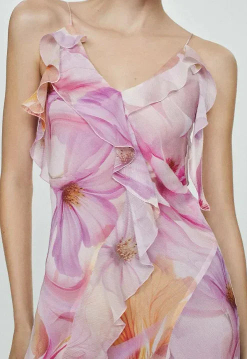 Women’s pink floral asymmetric midi dress featuring delicate ruffles and lightweight fabric for a comfortable fit.