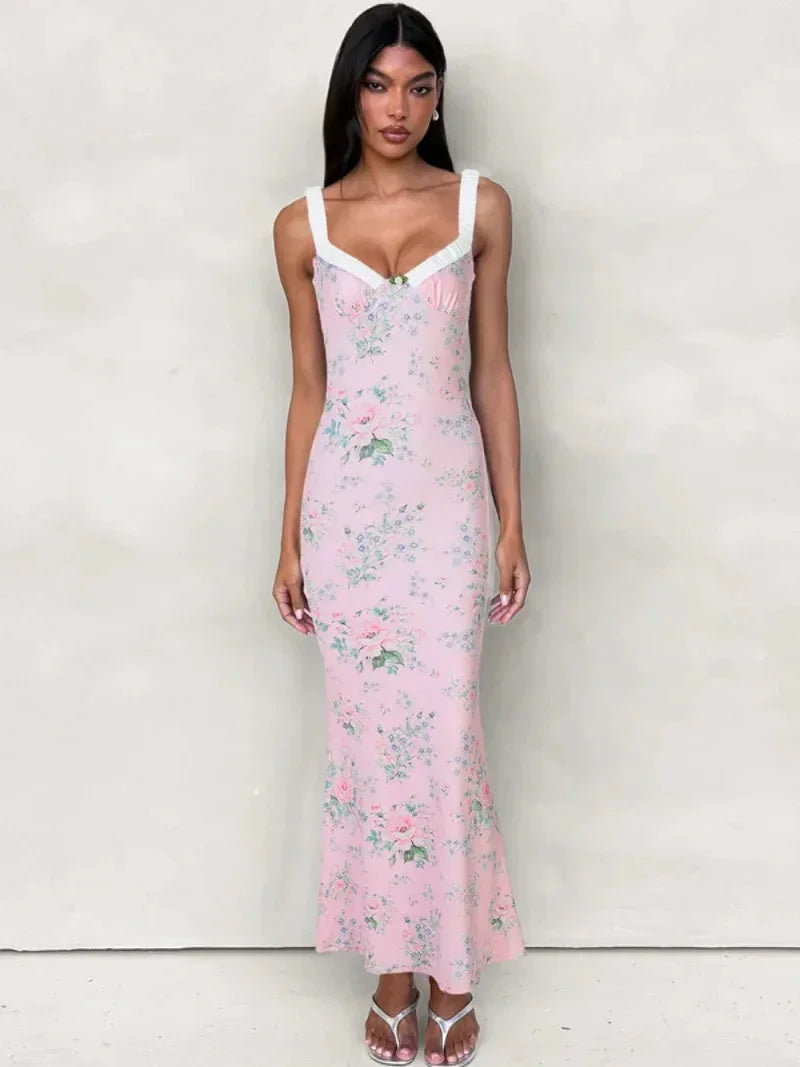 Women’s pink floral maxi dress featuring a sweetheart neckline, made from lightweight fabric with a flowy silhouette.