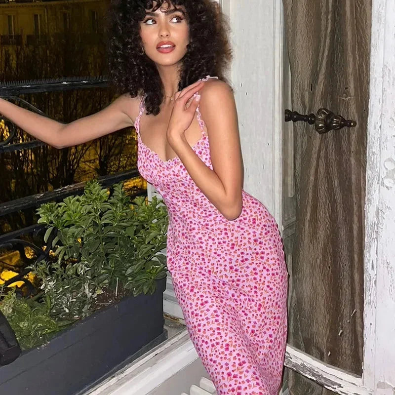 Women’s pink floral print midi dress with spaghetti straps, featuring a lightweight fabric and a flowy silhouette for…