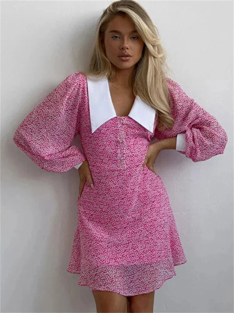Women’s pink floral mini dress with puff sleeves and white collar, crafted from lightweight cotton for comfort and style.