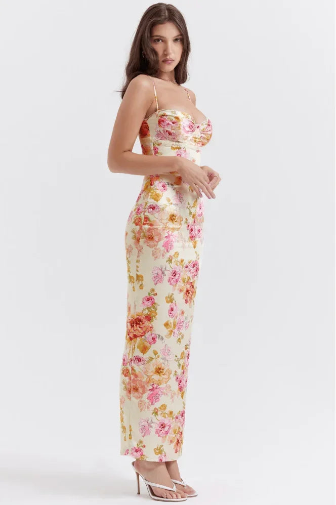 Women’s pink floral satin maxi dress featuring delicate straps and a flowing silhouette, perfect for warm weather outings.