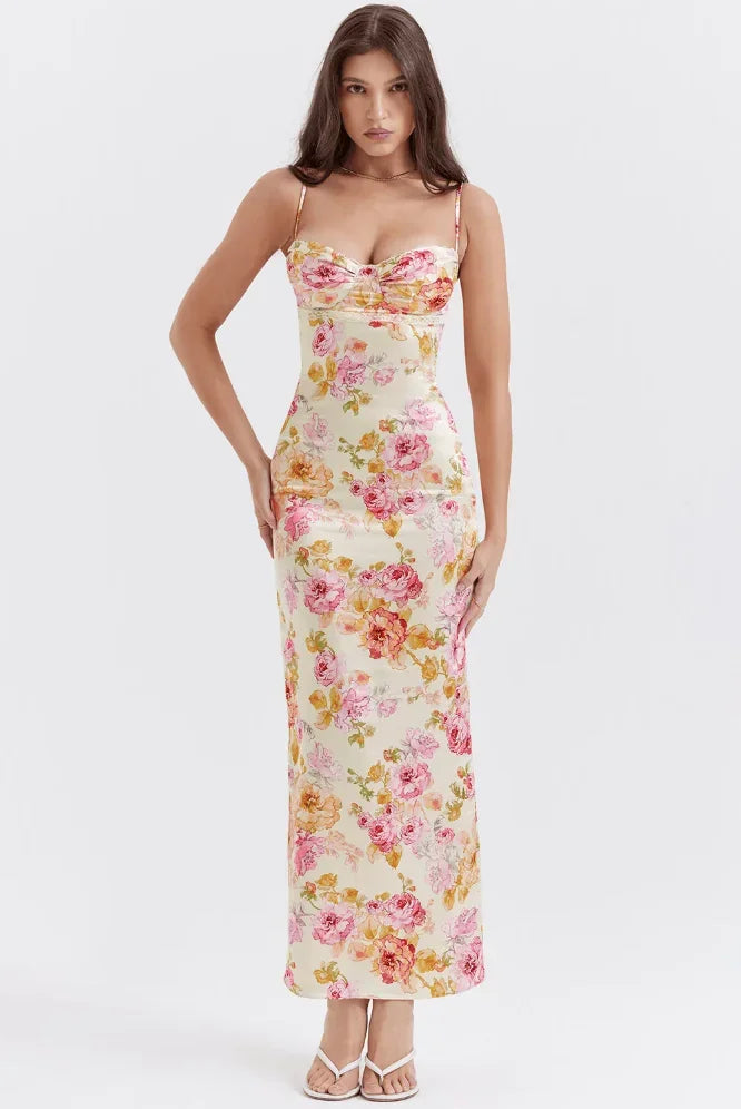 Women’s pink floral satin maxi dress featuring delicate straps and a flowing design, perfect for summer events.
