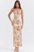 Women’s pink floral satin maxi dress featuring delicate straps and a flowing design, perfect for summer events.