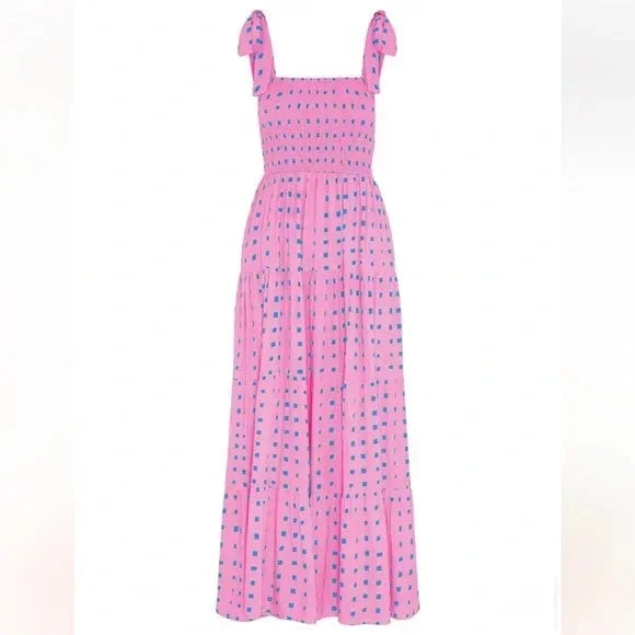 Women’s pink smocked maxi dress featuring tie straps and blue accents, made from breathable cotton for comfort and style.