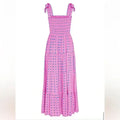 Women’s pink smocked maxi dress featuring tie straps and blue accents, made from lightweight cotton for comfort and style.