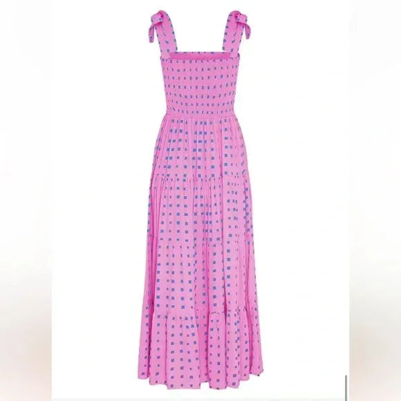 Women’s pink smocked maxi dress featuring tie straps and blue accents, made from lightweight cotton for comfort and style.