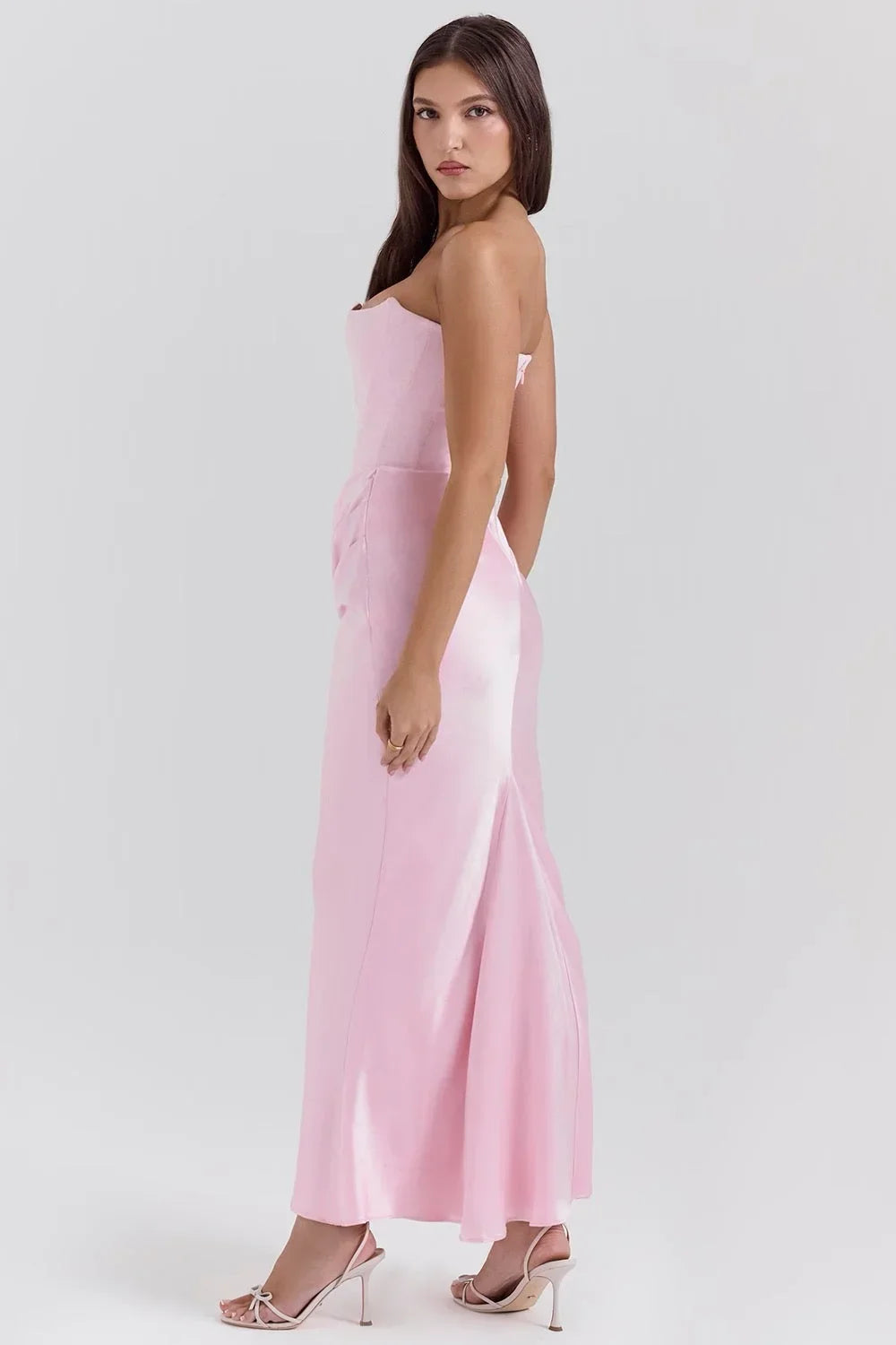Women’s pink strapless satin maxi dress featuring ruched detailing and a flowing silhouette, perfect for special occasions.