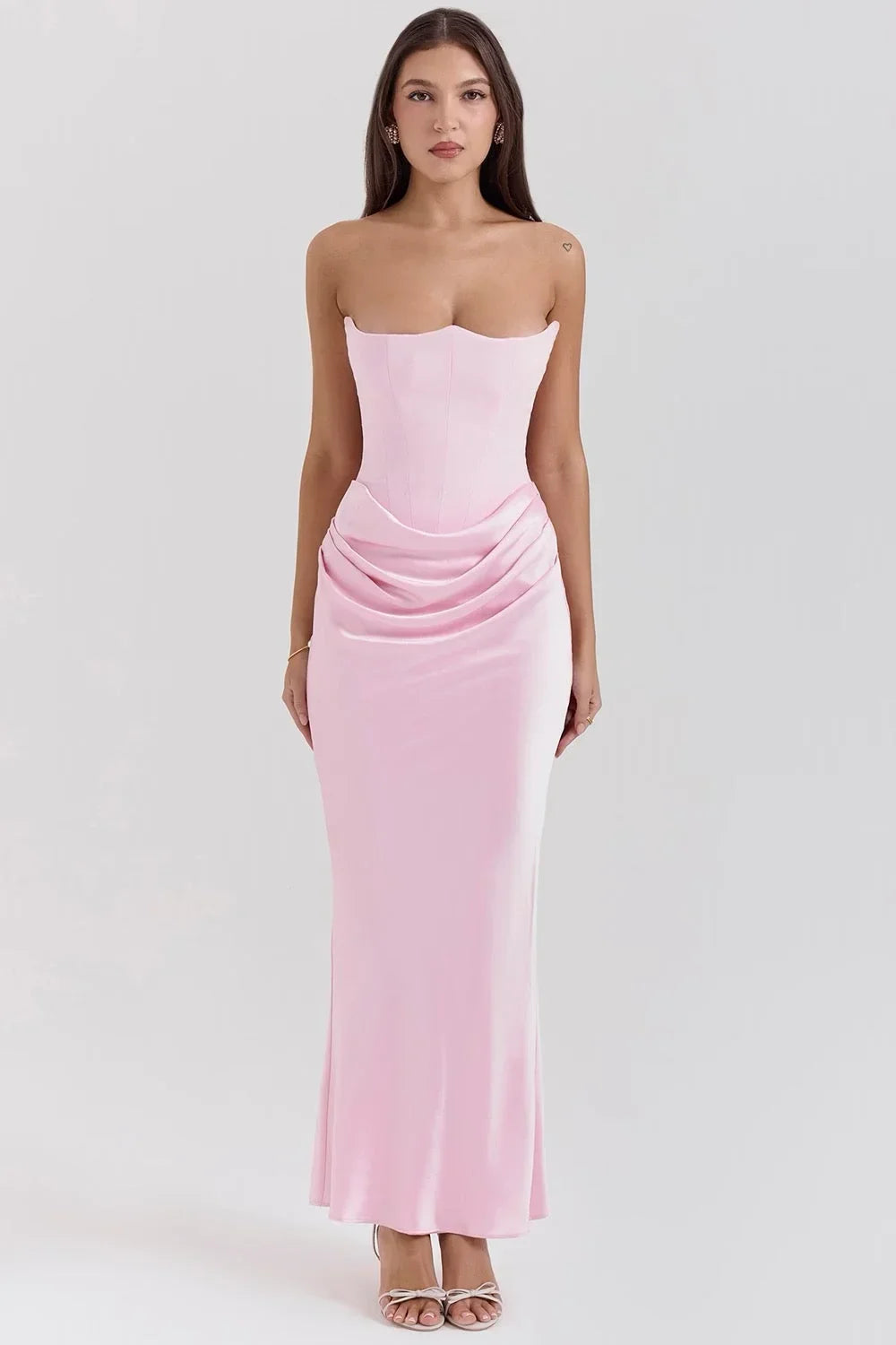 Women’s baby pink strapless satin maxi dress featuring ruched detailing and a flowy silhouette perfect for special occasions.