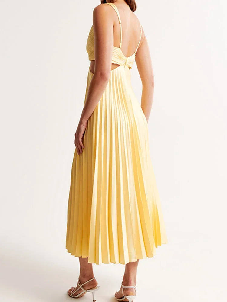 Women's pleated yellow maxi dress featuring a cut-out detail and plunging neckline, made from soft, breathable fabric.