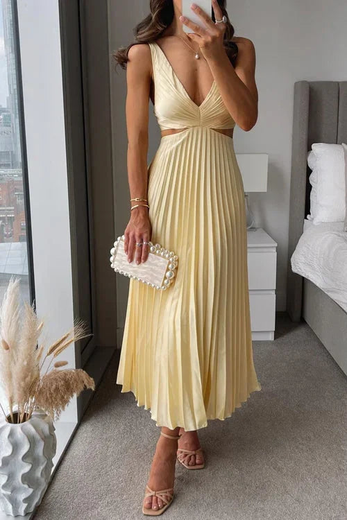 Yellow women's pleated maxi dress featuring cut-out details and a plunging neckline, made from lightweight, breathable…