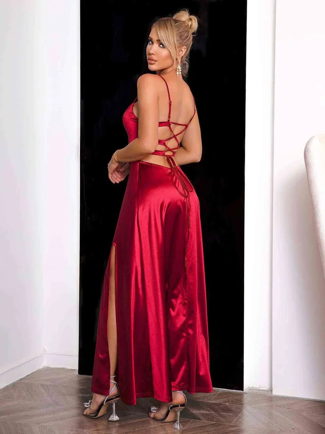 Women's red satin maxi dress featuring spaghetti straps and a flowing silhouette, perfect for elegant occasions.