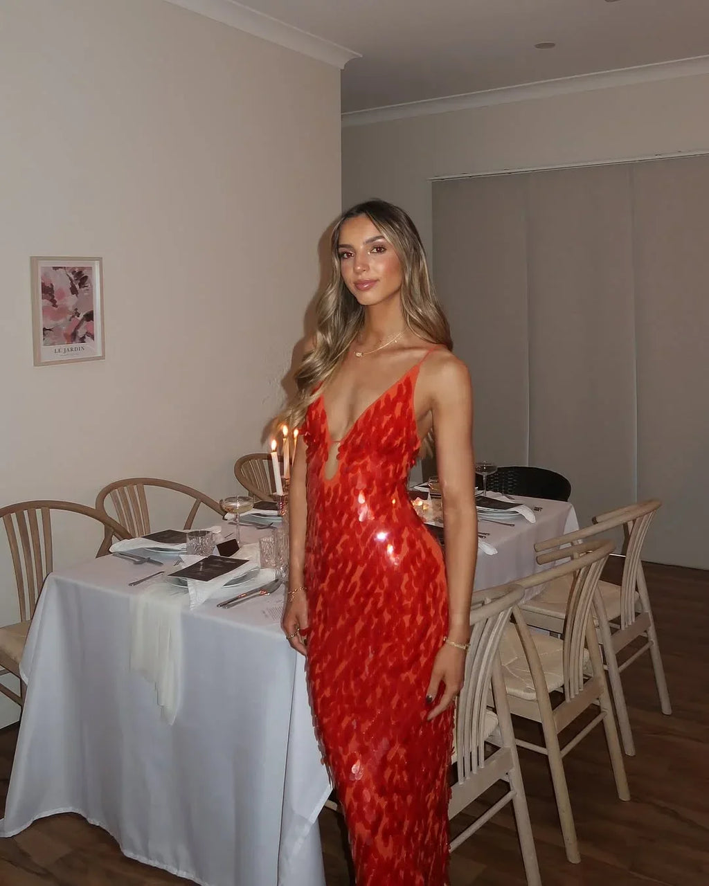 Women's red sequin maxi dress featuring a deep V-neck and shimmering sequins, perfect for special occasions.