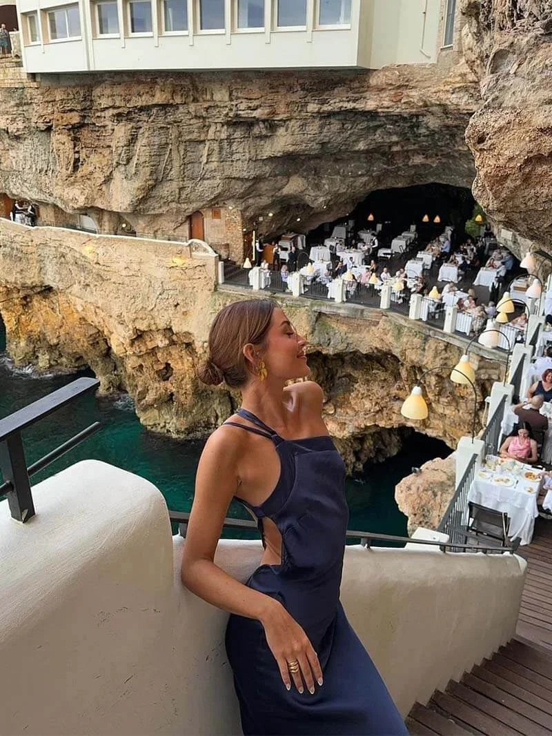 Backless satin maxi dress for women, featuring spaghetti straps and a flowing silhouette, ideal for summer events.