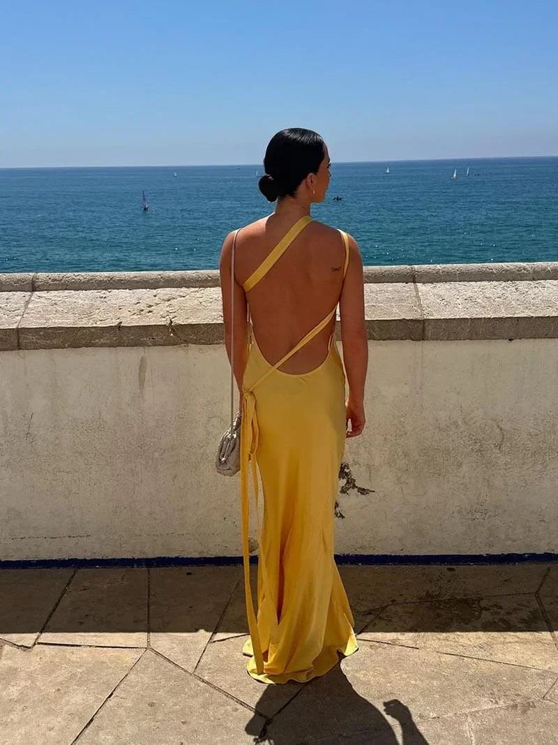 Satin backless maxi dress for women, featuring spaghetti straps and a flowing silhouette, perfect for warm-weather occasions.