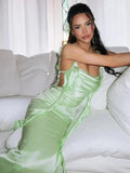 Green satin cowl neck dress for women, featuring side ties and an open back for a sleek and elegant silhouette.