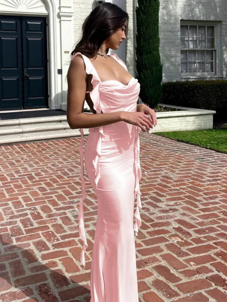 Pink satin cowl neck dress featuring side ties and an open back design, perfect for elegant occasions or casual wear.