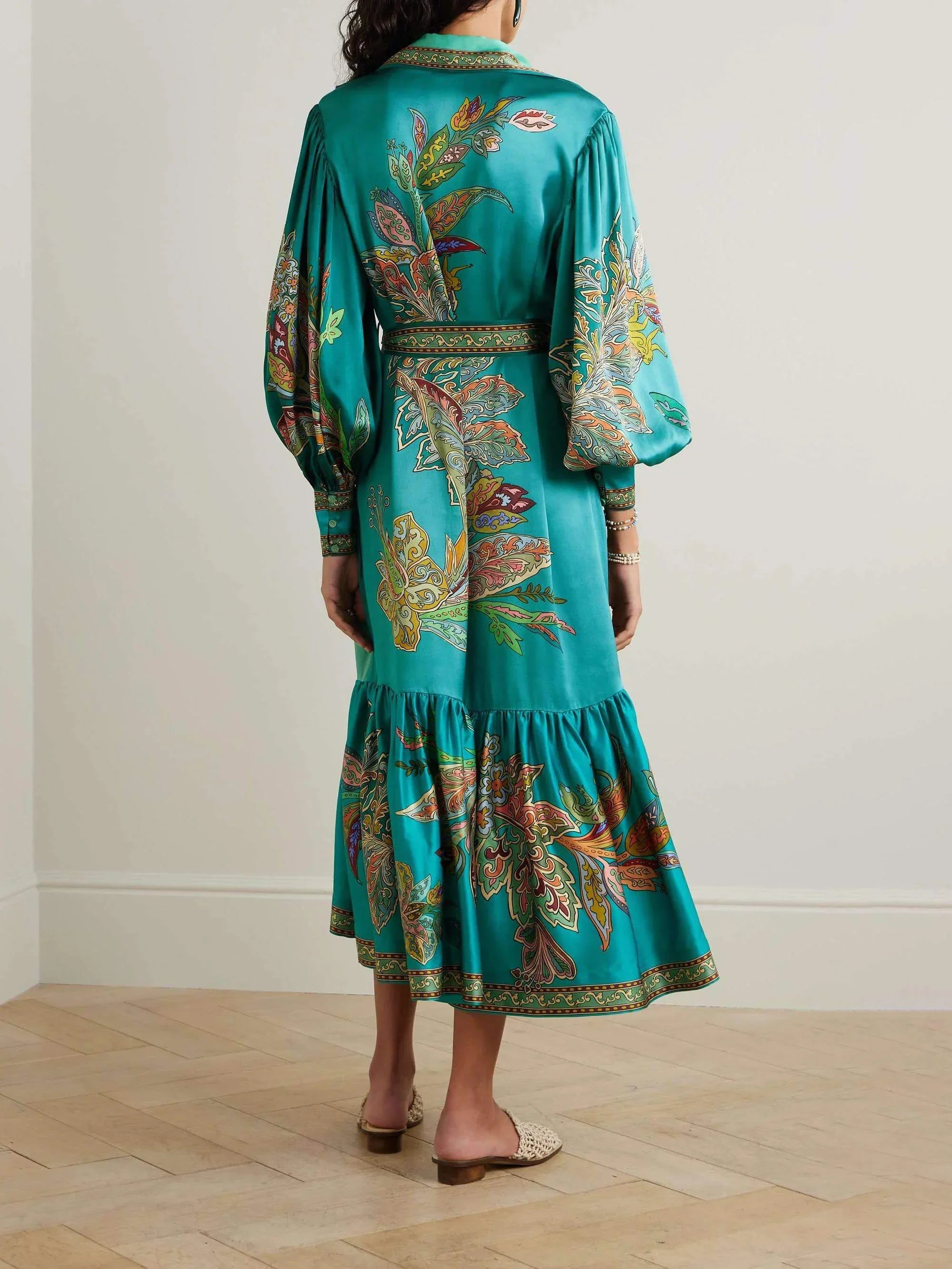 Women's satin floral midi dress with a belted waist and a tiered skirt, featuring soft fabric and vibrant floral print.