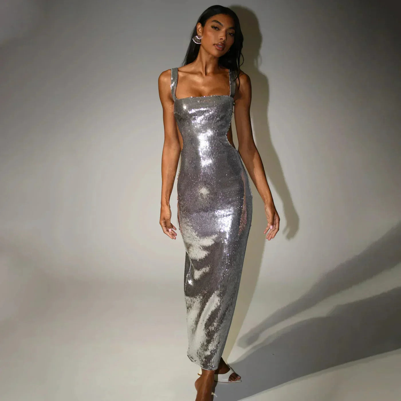 Women’s sequined maxi dress featuring a fitted silhouette, made from soft fabric with shimmering embellishments throughout.