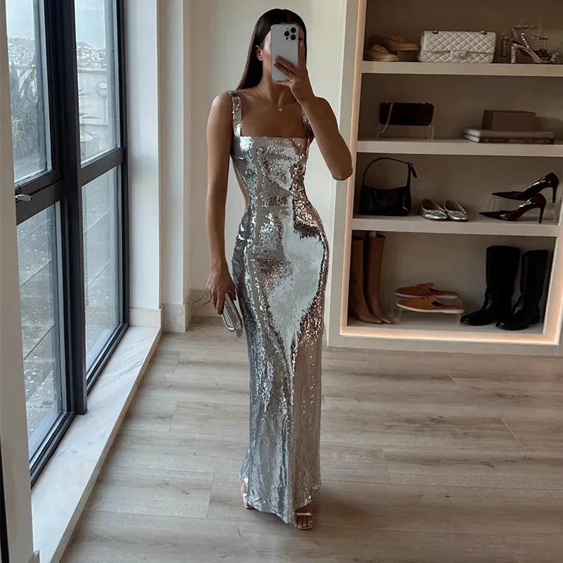 Silver sequined maxi dress featuring a fitted silhouette, perfect for evening events, crafted from lightweight, shimmering…