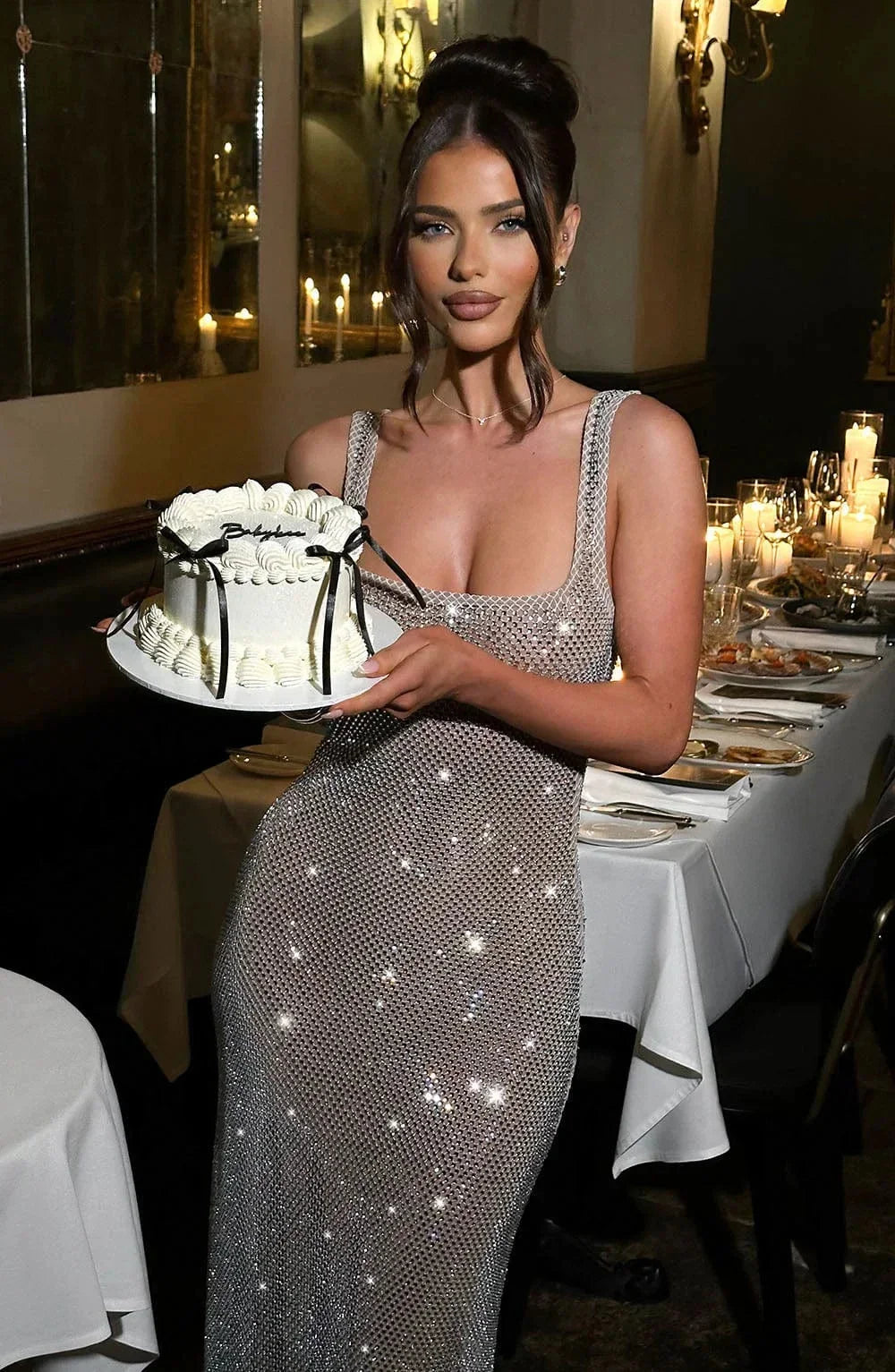 Women’s silver mesh sleeveless shimmer maxi dress, featuring a flowing design and shimmering material for a stylish evening…