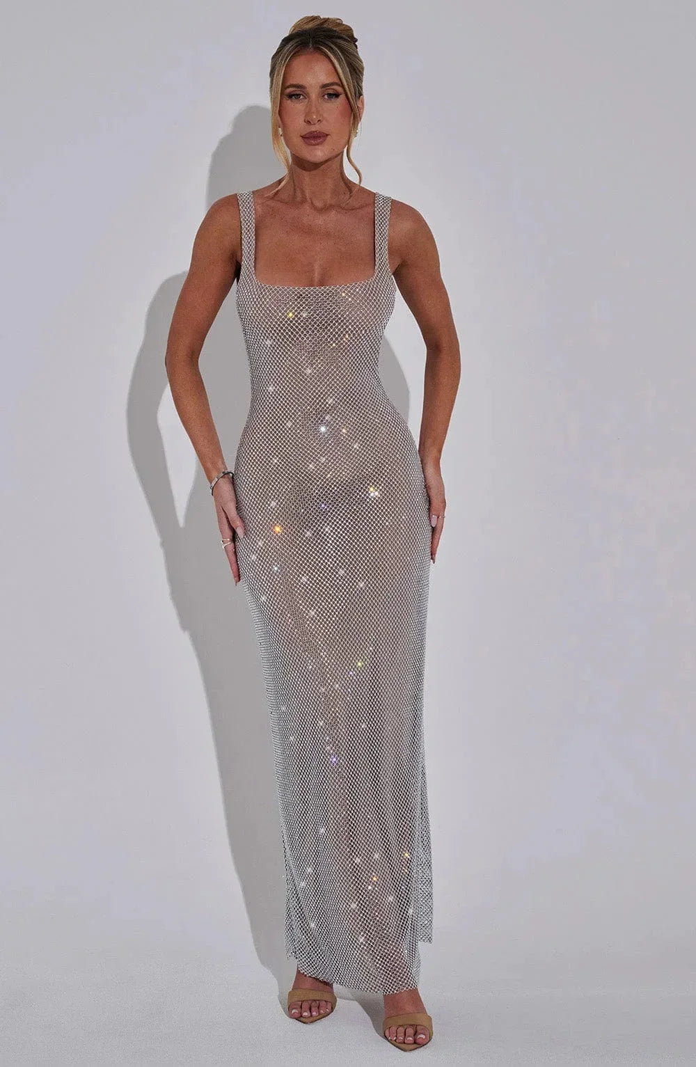 Women’s silver mesh sleeveless shimmer maxi dress featuring a flowing silhouette and delicate shimmer finish.