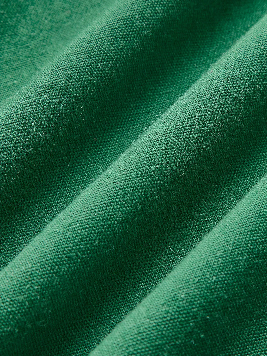 Women’s sleeveless A-line midi dress in soft cotton, featuring a side slit for easy movement and a flattering silhouette.