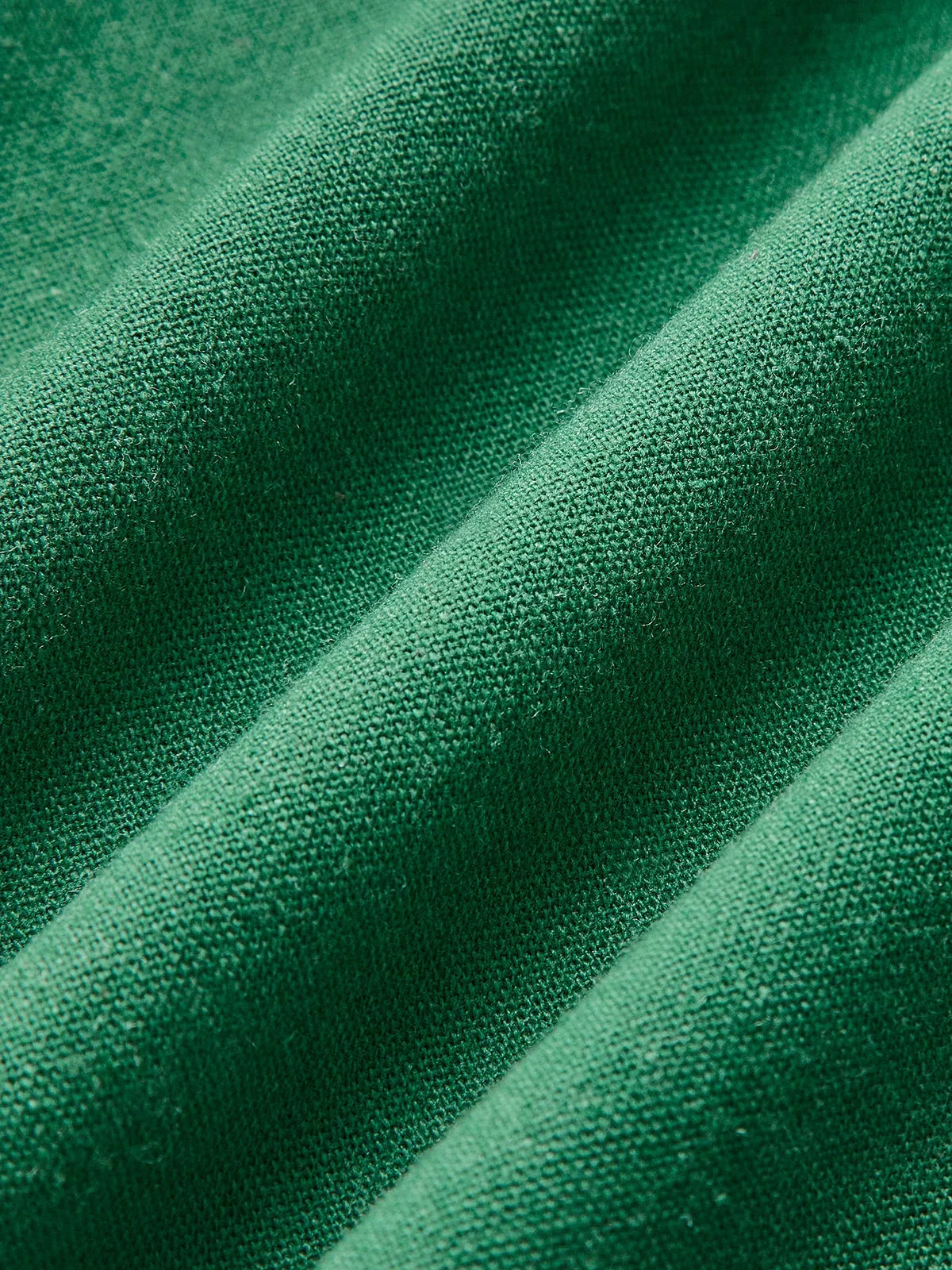 Women’s sleeveless A-line midi dress in soft cotton, featuring a side slit for easy movement and a flattering silhouette.