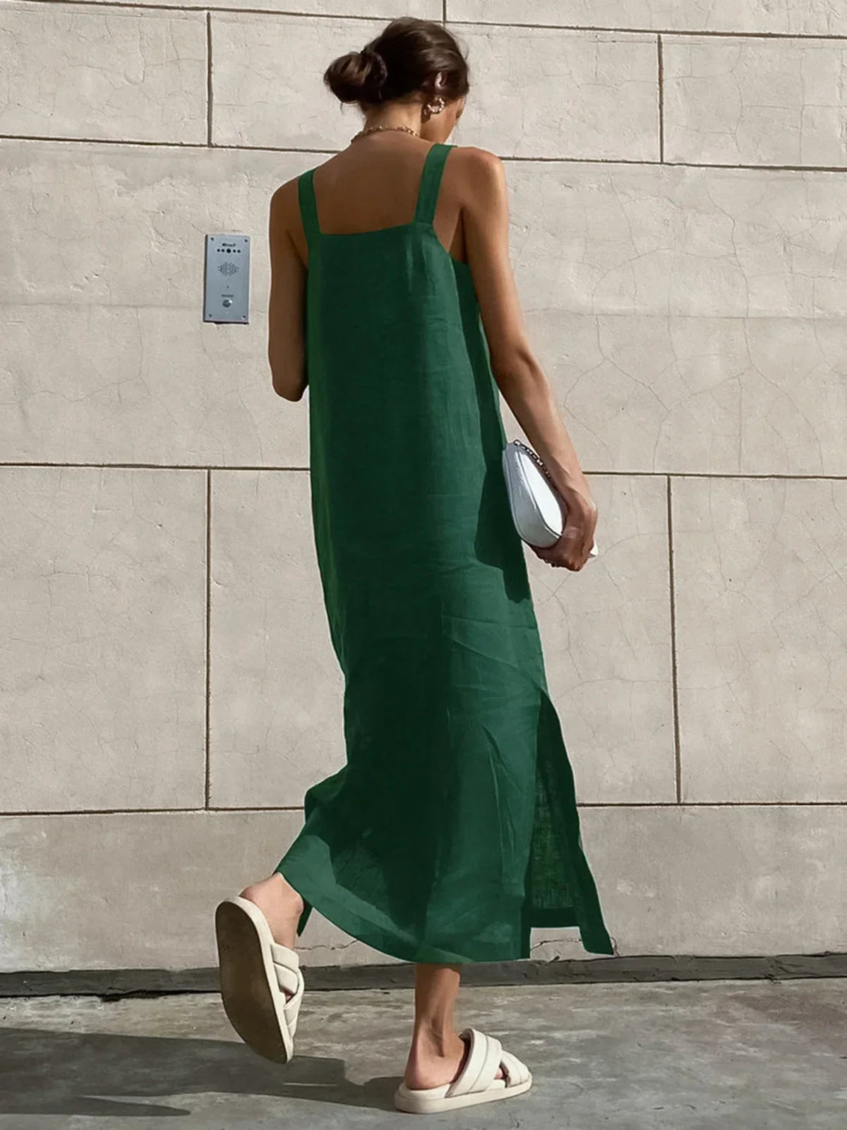 Women’s sleeveless A-line midi dress in lightweight fabric, featuring a flattering side slit for added movement and style.