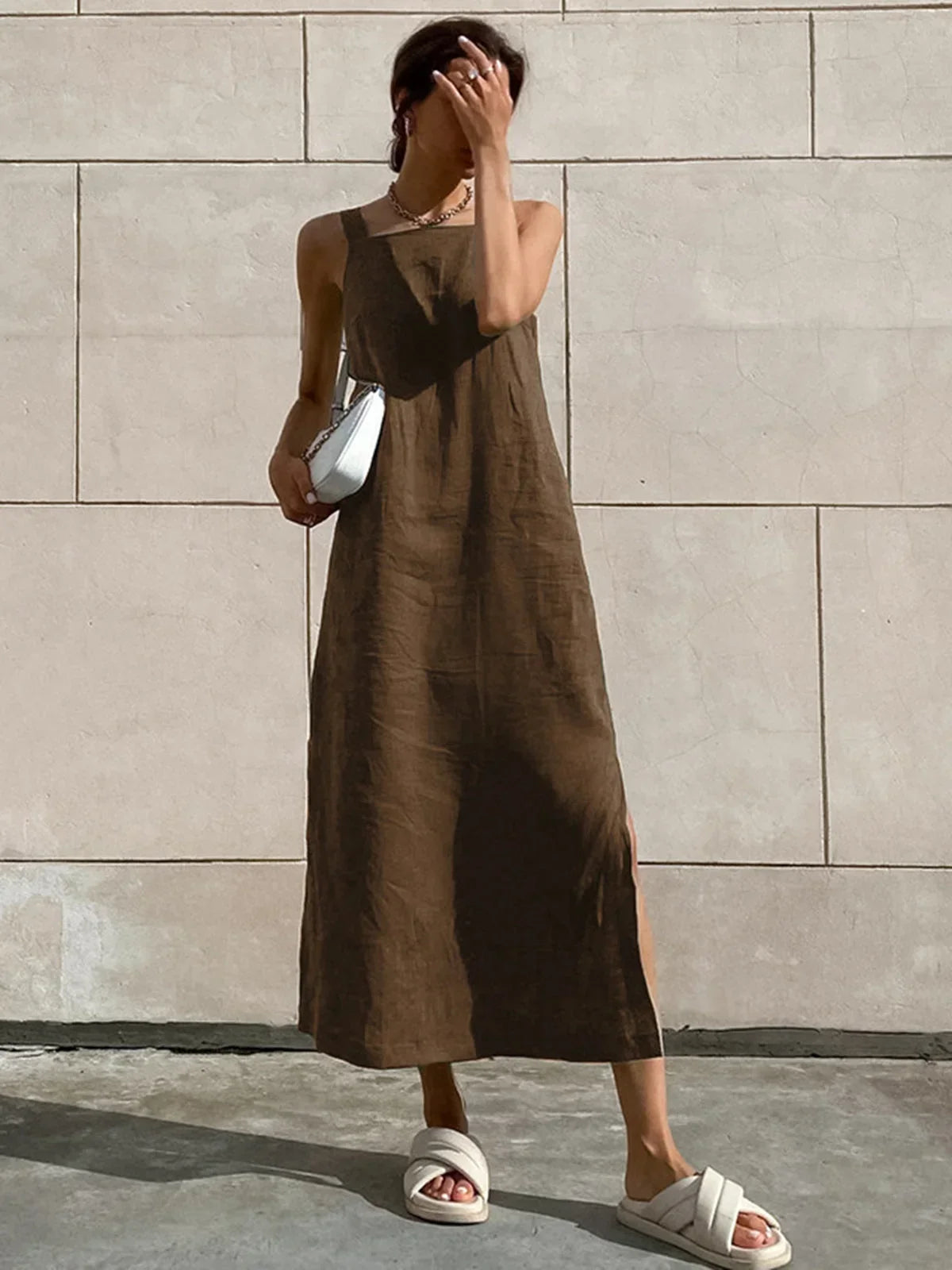 Dark brown women’s sleeveless A-line midi dress with side slit, made of soft fabric for comfort and a flattering fit.