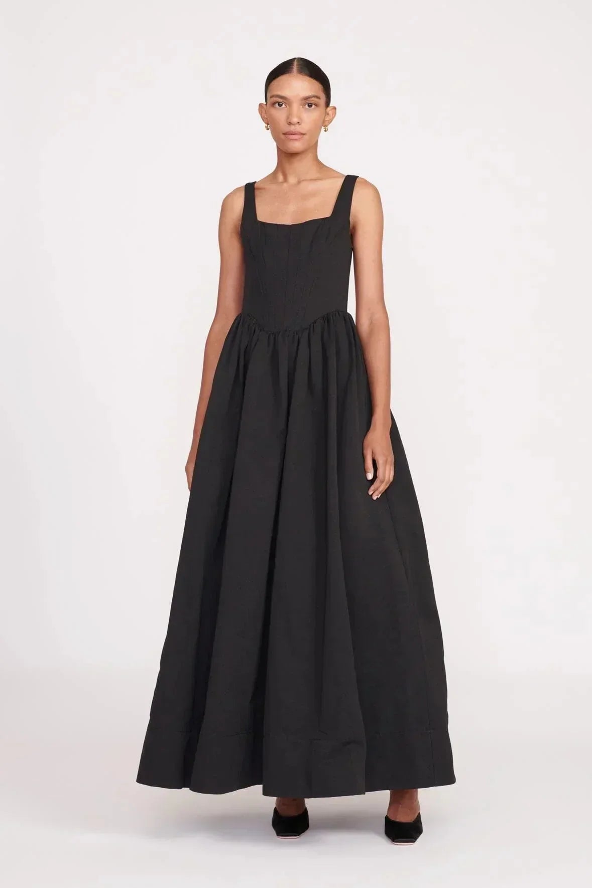 Women’s sleeveless black maxi dress with square neckline, flared skirt, made from soft fabric for comfort and ease of…