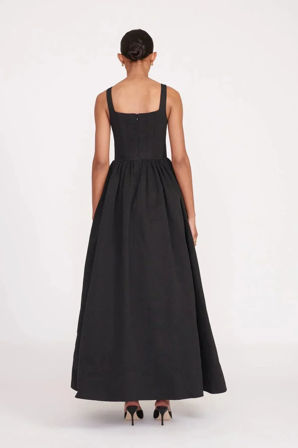 Women’s sleeveless black maxi dress featuring a square neckline and flared skirt, crafted from soft, breathable fabric for…