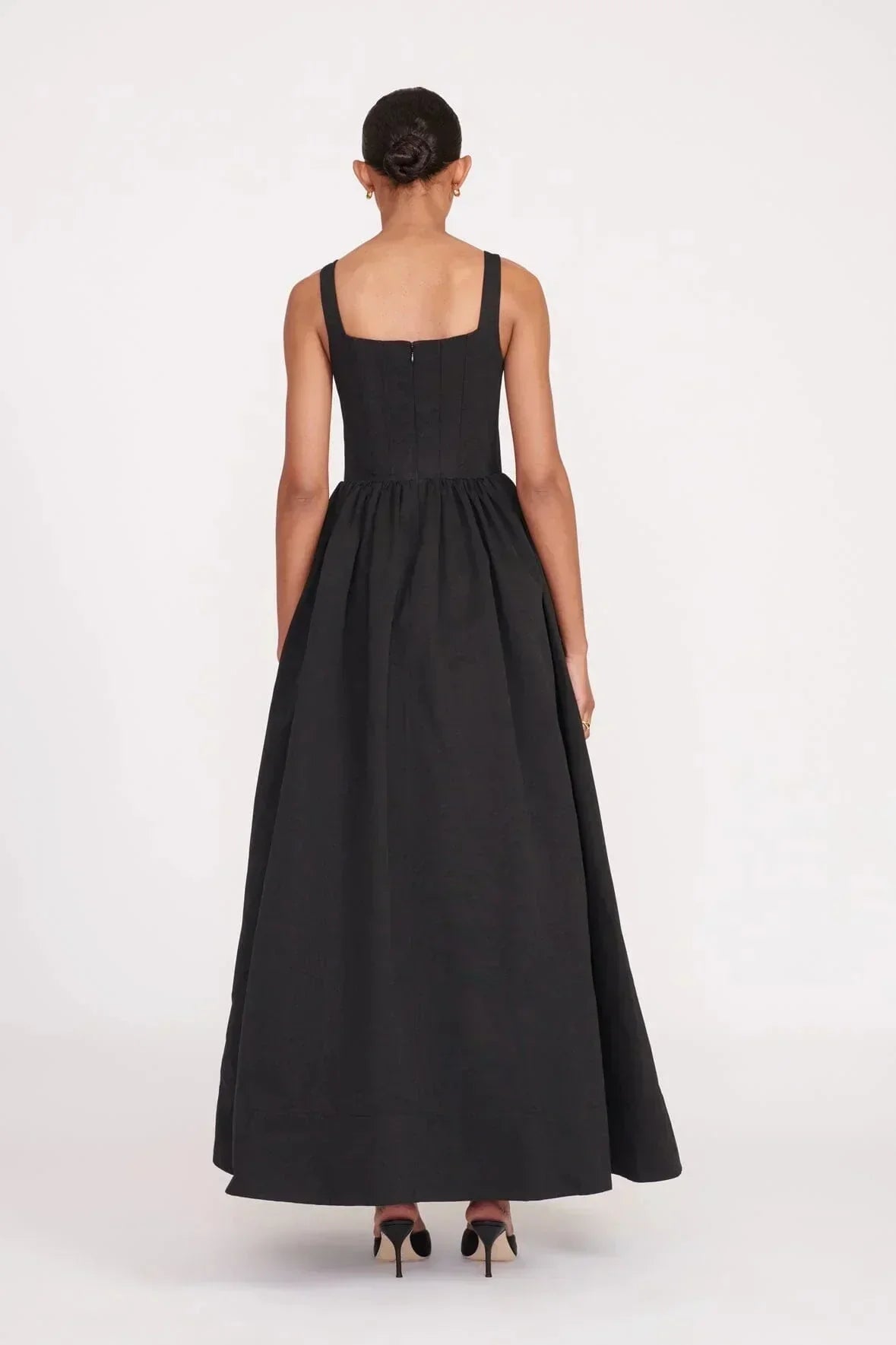 Women’s sleeveless black maxi dress featuring a square neckline and flared skirt, crafted from soft, breathable fabric for…