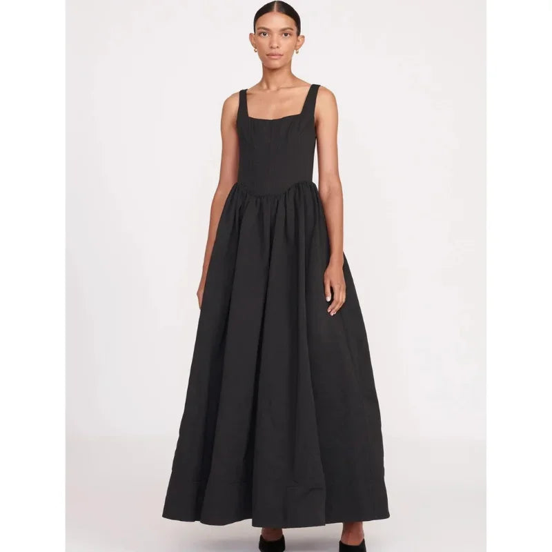 Women’s sleeveless black maxi dress with square neckline and flared skirt, made from soft, breathable fabric for comfort.