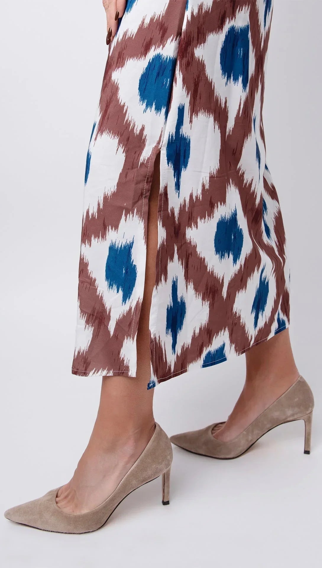 Women’s sleeveless brown and blue print midi dress with v-neck, made from lightweight fabric, featuring a flowing silhouette.