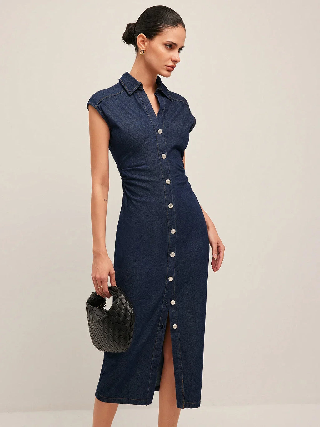 Women’s sleeveless dark blue denim midi dress with button-down front and classic fit, perfect for casual wear.