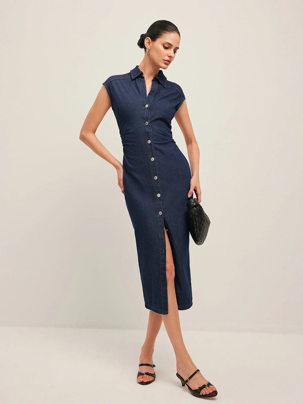 Women’s sleeveless navy denim midi dress with button-down front and classic collar, perfect for casual summer outings.